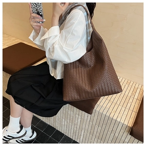Detail shot of the deep brown leather woven hobo bag showing large tote capacity and texture