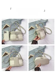 Detailed views of a beige cylinder crossbody bag with lace embroidery and zip closure