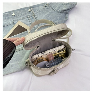 Internal view of beige woven box bag showing capacity for phone, lipstick and perfume