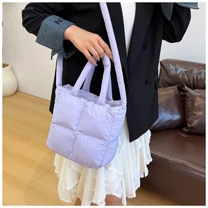 Detailed shot of light purple quilted tote bag with soft padded texture and dual straps
