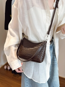 Dark brown woven leather bucket bag for women with an adjustable shoulder strap