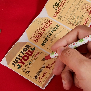 Christmas gift labels roll with Santa Express design and hand writing on kraft paper tags
