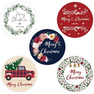 Five styles of circular Christmas stickers featuring snowflakes and festive greenery motifs