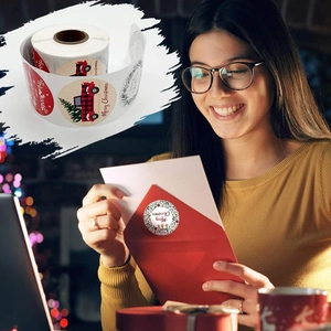Close-up of Merry Christmas roll stickers featuring festive tree and truck designs on envelopes