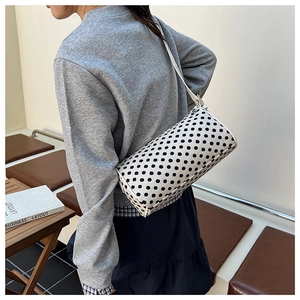 Polka dot cylinder shoulder bag worn by model, perfect for minimalist daily outfits