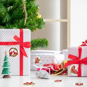 Christmas bird stickers on gift boxes with red ribbons and Joy to the World text