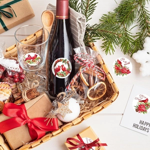 Close-up of bird-themed Christmas stickers on gift boxes and wine bottles