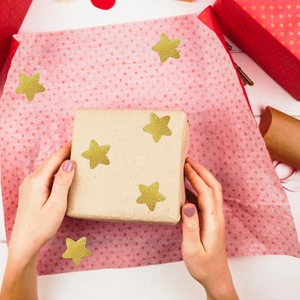 Brown kraft gift box decorated with self-adhesive gold star stickers for festive rewards
