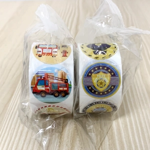 Close-up of fire engine and police themed reward stickers for kids craft decoration