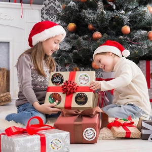 Christmas round gift stickers with Merry Christmas text on warm festive home background