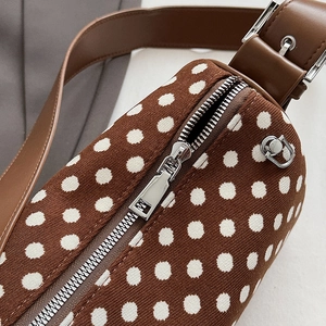 Polka dot pillow bag in brown knit fabric with leather strap and silver zipper detail