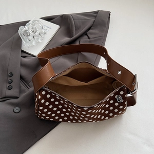 Brown polka dot pillow bag with leather shoulder strap and silver hardware accents