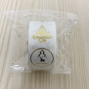 Detail of Christmas gold foil stickers roll with reindeer and Merry Christmas text