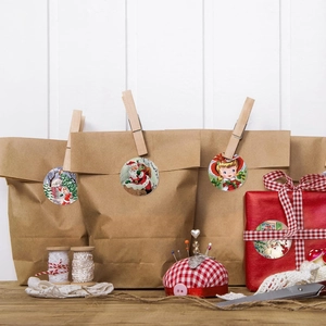 Christmas round gift stickers on kraft bags and plaid boxes with retro Santa patterns