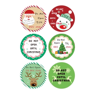 Roll of assorted Christmas round stickers featuring Santa, reindeer and tree designs