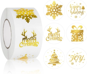 Macro view of gold foil Christmas stickers featuring deer, trees, and holiday greetings