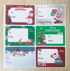 Detailed view of Christmas gift stickers with various holiday characters and to-from labels