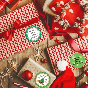 Christmas roll stickers with holiday patterns and greetings on a festive gift package
