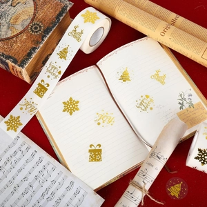 Christmas gold foil seal stickers with snowflakes and festive greetings on red velvet