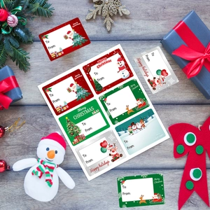 Christmas gift label stickers with Santa and reindeer designs on wood background