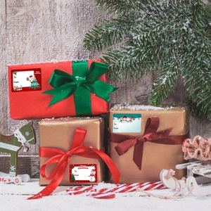 Christmas gift labels on gift boxes with Santa and reindeer motifs for holiday wrapping