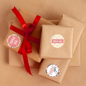 Roll of 8 thank you sticker patterns on kraft gift boxes with elegant red ribbons