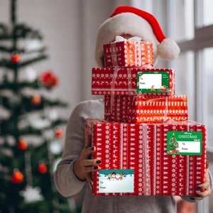 Close-up of decorative Christmas gift stickers with Merry Christmas labels on gift boxes