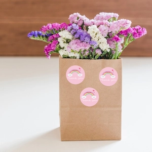 Rainbow smiley thank you sticker on brown paper gift bag with dried flowers decoration