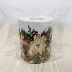 Close-up of Christmas decorative sticker roll with poinsettia and berry floral patterns