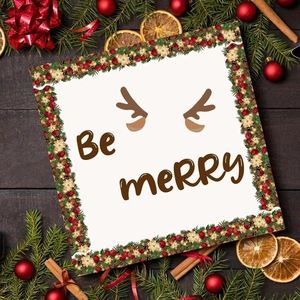 Christmas Be Merry wreath sticker roll on wooden background with holiday decorations