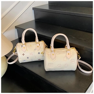 Detailed view of beige leather mini bags with animal embossing and colorful prints