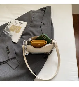 Interior storage space of the white chain shoulder bag with wallet and phone
