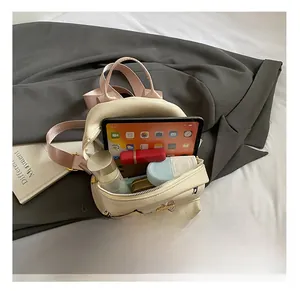 Mini backpack interior view showing storage capacity for tablet and cosmetics
