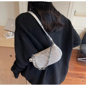Detail of grey marble pattern shoulder bag with silver chain and brand lettering