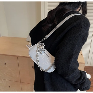Detail of grey marble pattern shoulder bag with silver chain and balloon dog charm