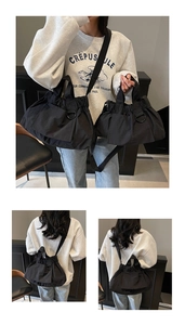 Detail of black pleated nylon tote bag with metal D-ring and versatile carry straps