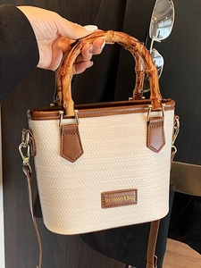 Chic woven bamboo handle bucket bag in cream white and brown leather finish