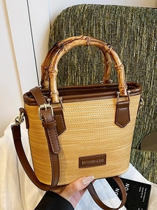 Straw bucket bag with distinctive bamboo handles and brown leather trim for women