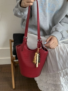 Red crocodile texture bucket tote bag with beaded charm and long shoulder straps