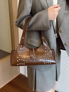 Brown rivet tote bag in glossy leather with silver studs and adjustable shoulder strap
