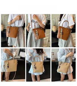 Detail view of woven leather bucket bag in dark brown and beige with adjustable straps