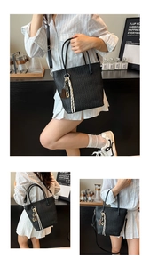 Close-up of black woven texture bucket bag with metal chain and hand-made leather tag