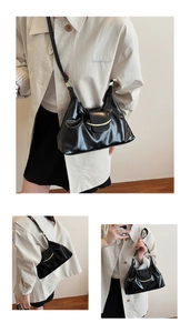 Detail of glossy pleated leather bag featuring vintage gold crescent metal buckle