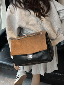 Fashionable chain crossbody tote bag featuring brown suede and black quilted leather
