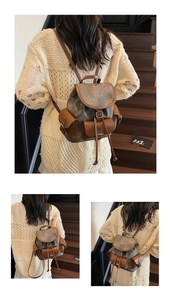 Detailed view of a vintage backpack featuring brown leather accents and multi-pocket design