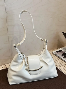 Minimalist white hobo shoulder bag with moon-shaped gold buckle on wooden background
