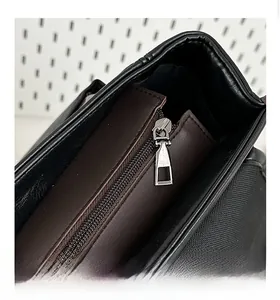 Detail shot of smooth silver zipper and stitching on the black leather backpack