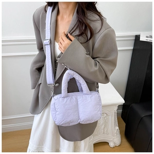 Detail view of the soft quilted texture and adjustable strap on the lilac cloud bag