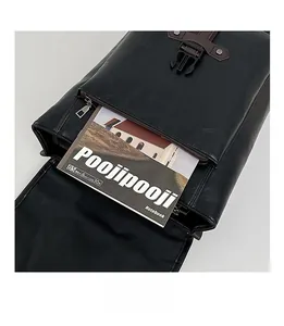 Front pocket detail of black leather backpack showing B5 notebook storage capacity