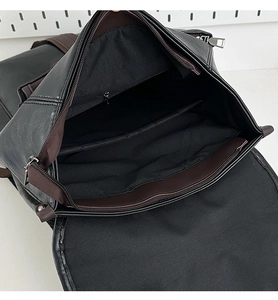 Interior detail of black leather backpack showing multiple storage pockets and zipper pocket